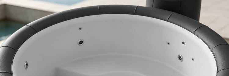 1783062556339320.png alt=Interior view of an empty round hot tub showing built-in jets and smooth white shell liner.png